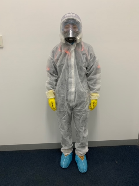 Clean Force team member dressed in full PPE gear fogging onsite